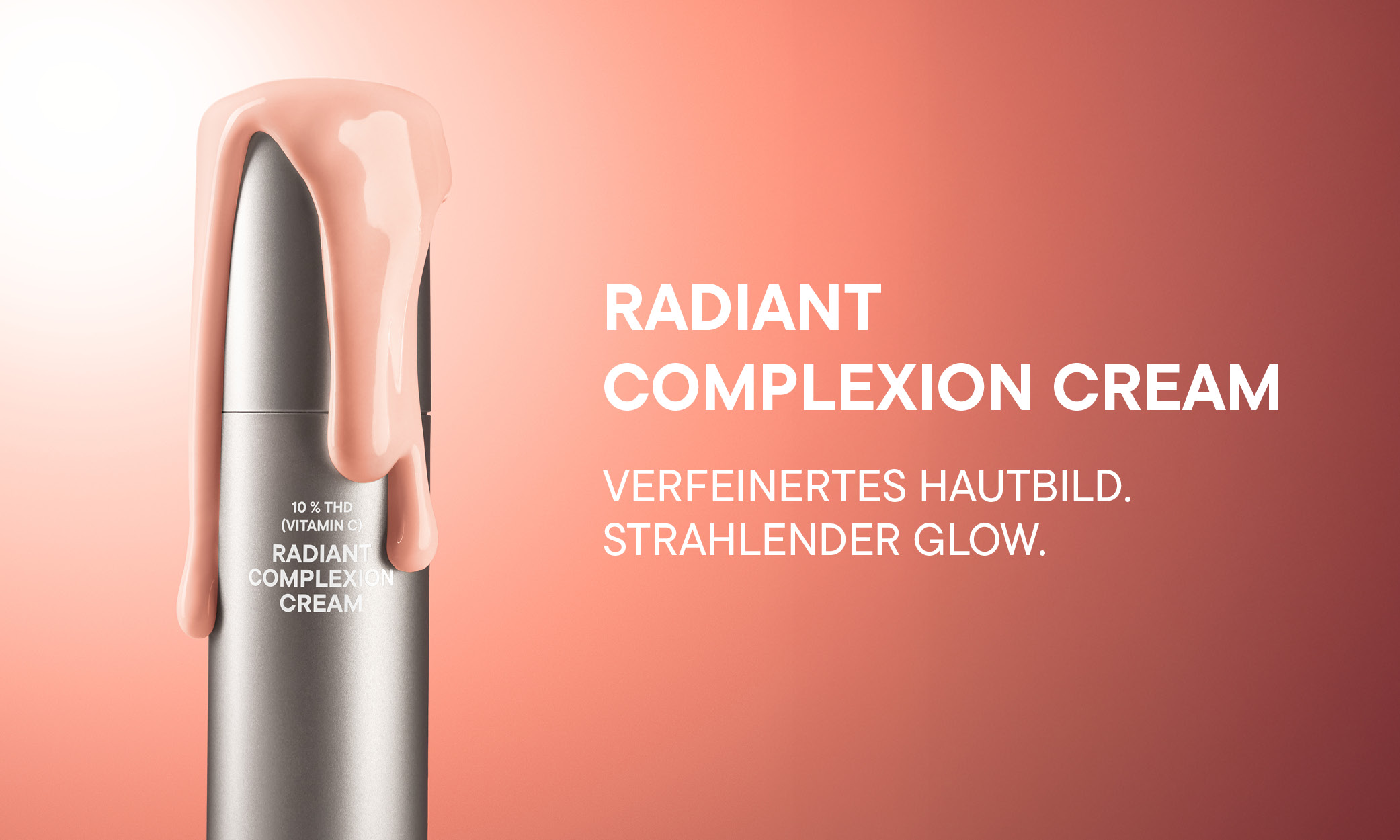 Silberne Tube der Radiant Complexion Cream mit 10 % THD (Vitamin C), aus der rosafarbene Creme läuft.